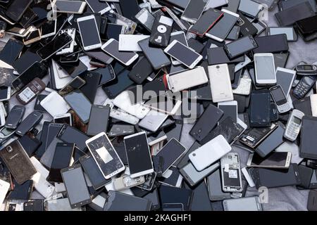 Prague, CZ - 05 September 2022:  A heap of Used mobile, Various brand Old smartphones gadgets with private media. Many types and generations of  mobil Stock Photo