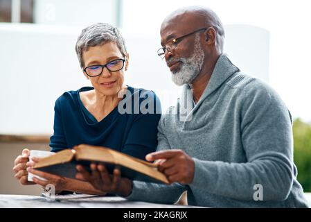 We never neglect having devotional time together. a happy senior couple enjoying quality time at the park. Stock Photo