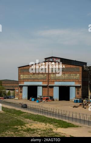 Gdansk, Poland - July 19 2022: Industrial building at the Gdansk Shipyard, former Lenin Shipyard, prefabrication workshop and heavy cranes large Polish shipyard. Cranes at historical shipyard in Gdansk headquarters of Solidarity Polska Stock Photo