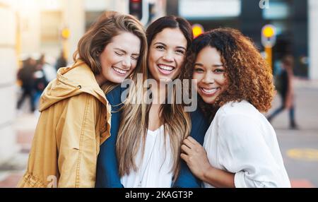 Were inseparable. three friends having fun in the city. Stock Photo