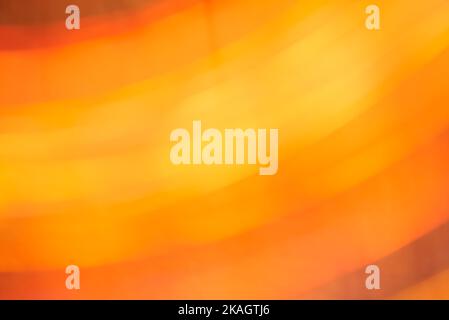 Abstract orange and yellow background, blur dynamic flowing design, moving lights in warm vivid colors. Stock Photo