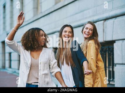 Were taking this city over. three friends having fun in the city. Stock Photo