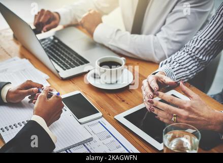 Getting down to the real work behind success. a group of unrecognisable businesspeople having a meeting in an office. Stock Photo