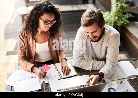 Meeting with a change of scenery. two designers having a meeting at a coffee shop. Stock Photo