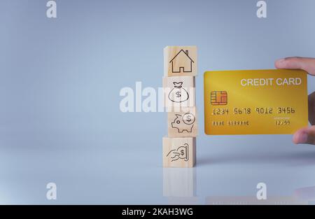 Concept of selling a house. A hand is holding credit card on a white background. Real estate agent offer house, property insurance and security, affor Stock Photo