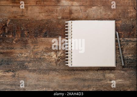 Mockup blank notebook and pen on old rustic wooden table. Mockup blank notebook and pen on old rustic wooden table Stock Photo