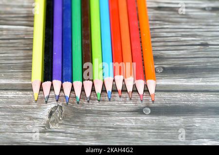wood color pencils of different colors for painting isolated on wooden background, back to school concept, school supplies and education background, s Stock Photo