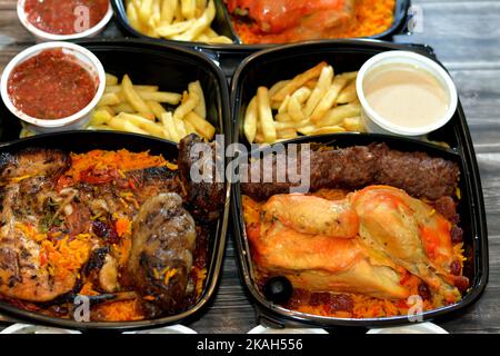 Traditional gulf food cuisine background of Yemen chicken mandi with tomato dakos sauce, barbecued grilled chicken, beef meat gbarbecued kofta, tarb k Stock Photo