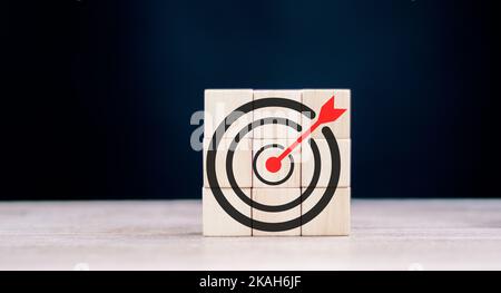 Objective and target concept. Arrow upward to target on wooden cubes. Stock Photo