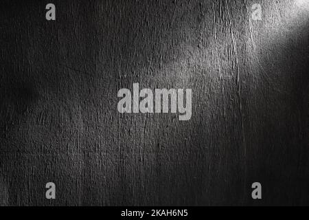 Black rough plywood texture with beam lighting. Stock Photo