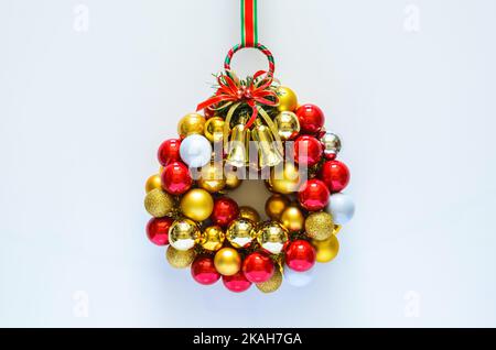 Colorful Christmas wreath made from baubles ornament on white background. Minimal holiday concept. Stock Photo