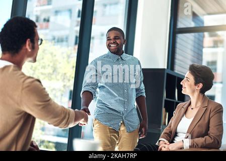 I cant wait to share my creative ideas with you. designer shaking hands in the office. Stock Photo