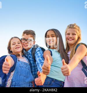 What we learn becomes who we are. a group of elementary school children together. Stock Photo