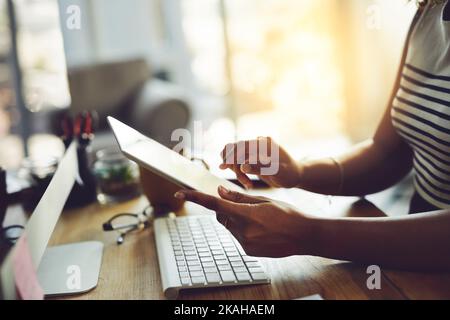 Working wirelessly. an unrecognizable businesswoman working on a digital tablet. Stock Photo