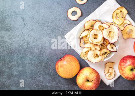 Homemade dried organic apple sliced chips in bowl. Healthy snacks concept. Top view Stock Photo