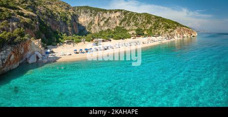 Gjipe Beach. Panoramic, aerial  view from the sea side. Clear waters of the Ionian Sea, a clean pebble beach and an impressive canyon with an olive gr Stock Photo