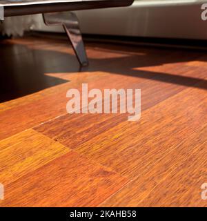 Mahogany flooring parquets in the room with armchairs in a standard home environment, mahogany wood grain texture Stock Photo