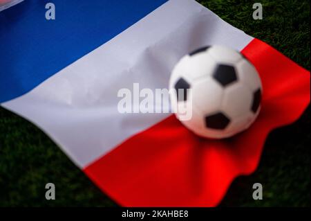 France national football team. National Flag on green grass and soccer ball. Football wallpaper for Championship and Tournament in 2022. World interna Stock Photo