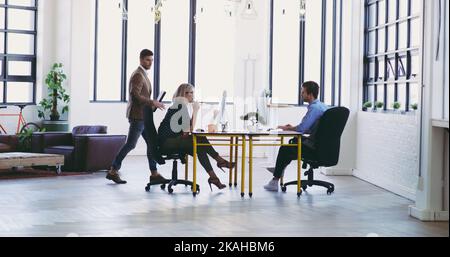 Focused on getting their jobs done. Full length shot of a group of designers working in their creative office. Stock Photo