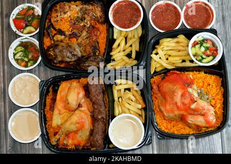 Traditional gulf food cuisine background of Yemen chicken mandi with tomato dakos sauce, barbecued grilled chicken, beef meat gbarbecued kofta, tarb k Stock Photo