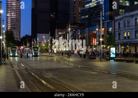 Light rail trams at Circular Quay at blue hour in Sydney, Australia Stock Photo