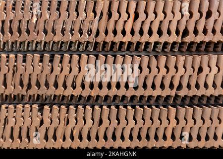Three rows of upright old roof tiles in close-up Stock Photo