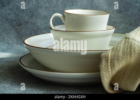 Close-up of an empty coffee cup on a stack of bowls and plates Stock Photo