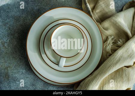 Overhead view of an empty coffee cup on a stack of bowls and plates Stock Photo
