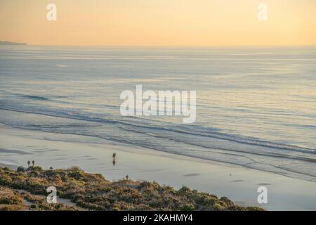Sunset landscape of peaceful beach and shoreline at Del Mar Southern California. Peaceful scenery with sea and sand overlooking golden horizon on a pe Stock Photo