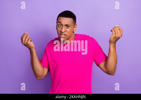 Photo of unhappy dissatisfied young student guy wear pink t-shirt finger argue dont like his new history teacher eyebrow up isolated on violet color Stock Photo