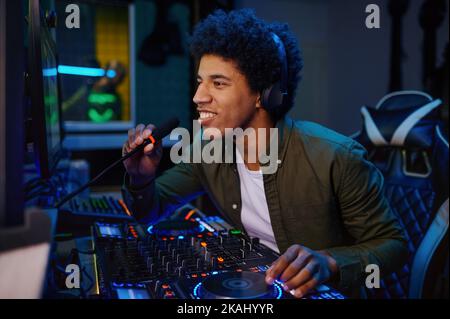 Radio host speaking into microphone Stock Photo