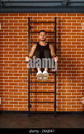 Handsome muscular man doing sport exercises Stock Photo
