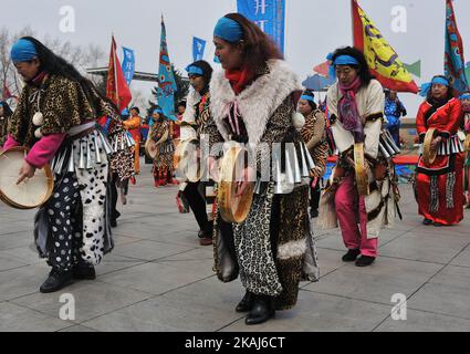 People perform Shaman Dance to pray at the opening of the Kaijiang ...