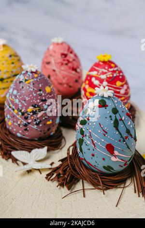 The chocolate easter eggs in the chocolate straws decorated in different colors Stock Photo