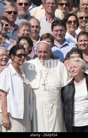 Pope Francis poses for a family picture with some of the members of Rev. Jacques Hamel's parish church, among them his sister Roselyne Hamel, second from right, and Rouen bishop Dominique Lebrun, right, at the end of his weekly general audience in St.Peter's Square at the Vatican, Wednesday, Sept. 14, 2016. Francis celebrated a morning Mass on Wednesday in memory of the Rev. Jacques Hamel. Two extremists slit Hamel's throat in his church in Saint-Etienne-du-Rouvray, outside Rouen, on July 26. Police later killed them; the Islamic State group claimed responsibility. (Photo by Massimo Valicchia/ Stock Photo