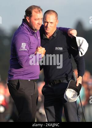 Alex Noren of Sweden celebrates on the 18th green with Peter Hanson (SWE) during The British Masters 2016 supported by SkySports  Round  4at The Grove Golf Course on October 16, 2016 in Watford, England. (Photo by Kieran Galvin/NurPhoto) *** Please Use Credit from Credit Field *** Stock Photo