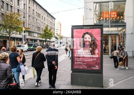 Strasbourg, France - Oct 28, 2022: Street advertising with a young girl wearing a mustache and sexist text wited above by activists Stock Photo