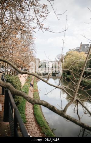 Strasbourg, France - Oct 28, 2022: View from above of senior couple walking along Ill river on a fall day sightseeing Strasbourg Stock Photo