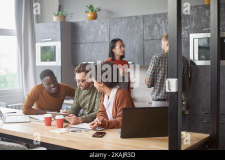 business team using a digital tablet at work in a coworking cent Stock Photo