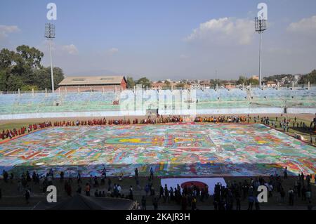 Nepalese Buddhist Kora Arounds World's largest Thangka Painting of 12 important lifestyle of the Lord Gautam Buddha showcased at Dashrath Rangasala Stadium, Kathmandu, Nepal on Friday, November 11, 2016. The effort of more than 10,000 volunteers from over 16 countries, the thangka was finally completed in 2002. The painting representing 12 important lifestyle of the Lord Gautam Buddha. The length measuring a thangka 70m by 50m and thangka weights around 1900 kilograms with 81 different pieces of fabric stitching together. (Photo by Narayan Maharjan/NurPhoto) *** Please Use Credit from Credit F Stock Photo