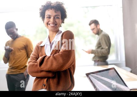 young entrepreneur standing near a desktop in a coworking center . Stock Photo