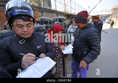 Nepalese people filling form exchange Indian currency at Nepal Rastra Bank - Central Bank of Nepal, Kathmandu, Nepal on Friday, December 16, 2016. Nepal Rastra Bank - Central Bank of Nepal is the only bank to exchange Nepalese currency into indian currency in Nepal. (Photo by Narayan Maharjan/NurPhoto) *** Please Use Credit from Credit Field *** Stock Photo