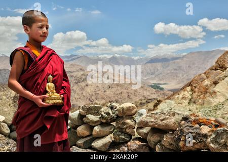 Young Buddhist monk holding a small golden Buddha statue at the Hemis Monastery (Hemis Gompa) in Hemis, Ladakh, Jammu and Kashmir, India. Behind are the magnificent mountains surrounding the Indus Valley. (Photo by Creative Touch Imaging Ltd./NurPhoto) *** Please Use Credit from Credit Field *** Stock Photo