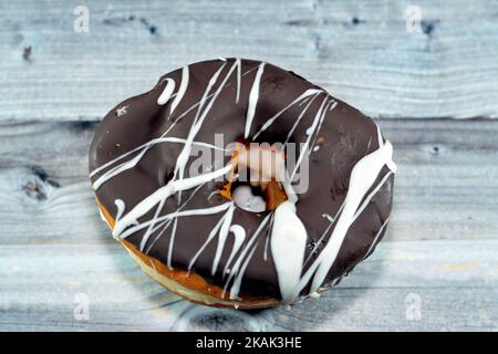 Brown and white chocolate ring donut, A glazed, yeast raised, American style ring doughnut, type of food made from leavened deep fried dough sweet sna Stock Photo