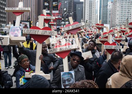 People raise over 750 wooden crosses which are dedicated to lives lost in 2016 in Chicago during a peace march on December 31, 2016. Over 750 people were killed this year in Chicago, making it the deadliest year in almost two decades. (Photo by Max Herman/NurPhoto) *** Please Use Credit from Credit Field *** Stock Photo