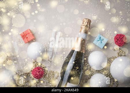 Abstract Christmas background with champagne and Christmas decorations, with golden snowflakes and copy space for text Stock Photo