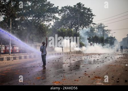 Police fire teargas shells and water cannon on Pro-Sundarbans activists at Shahbagh during a half-day shutdown in Dhaka. January 26, 2017. (Photo by Turjoy Chowdhury/NurPhoto) *** Please Use Credit from Credit Field *** Stock Photo