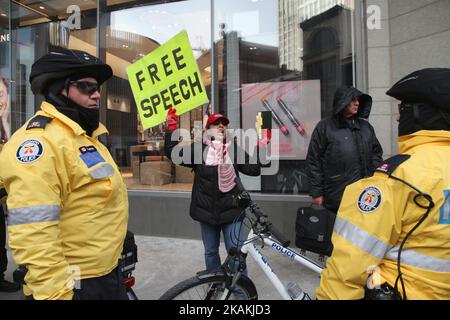 Police cordon off an Iranian woman holding a copy of the Quran and a sign with the words 'Free Speech' as she yells anti-Muslim rhetoric about Muslims planning terror attacks in Canada on February 04, 2017 in downtown Toronto, Ontario, Canada. (Photo by Creative Touch Imaging Ltd./NurPhoto) *** Please Use Credit from Credit Field *** Stock Photo