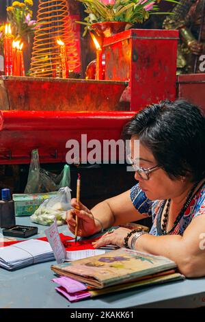 Vietnamese fortune teller writing inscription inside Jade Empress
