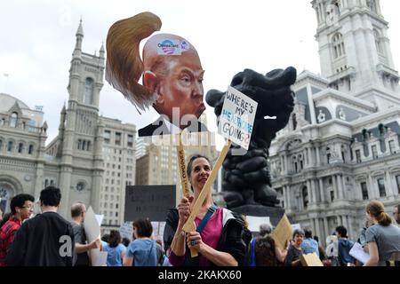 At a Feb. 25, 2017 Affordable Care Act repeal protest rally in Philadelphia, PA, artist Carla Krash holds up a sign with a cartoon image of Donald Trump, that includes a movable hair piece. (Photo by Bastiaan Slabbers/NurPhoto) *** Please Use Credit from Credit Field *** Stock Photo